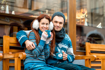 Young couple with coffee in winter outside