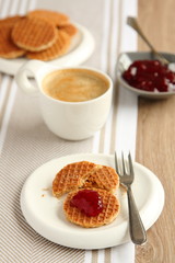 Mini stroopwafels (syrupwaffles) with cup of coffee and jam