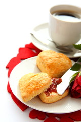 Heart shaped scones with strawberry jam and a cup of tea