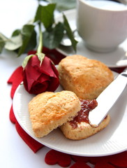 Heart shaped scones with strawberry jam and a cup of tea