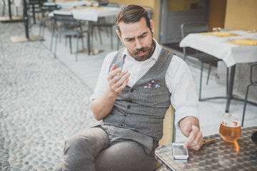 handsome big moustache hipster man using smart phone