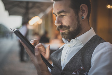 handsome big moustache hipster man using tablet