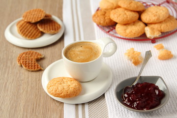 Cup of espresso with coconut cookies on a plate