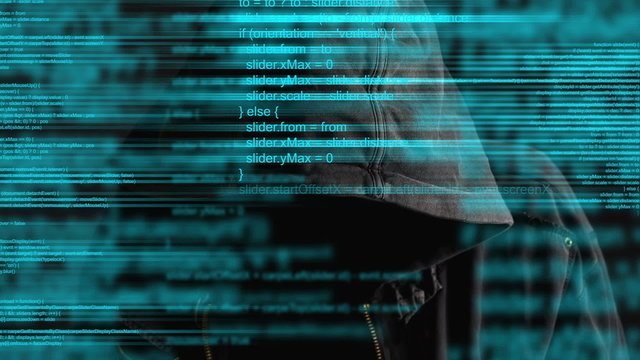 Faceless hooded anonymous computer hacker with programming code