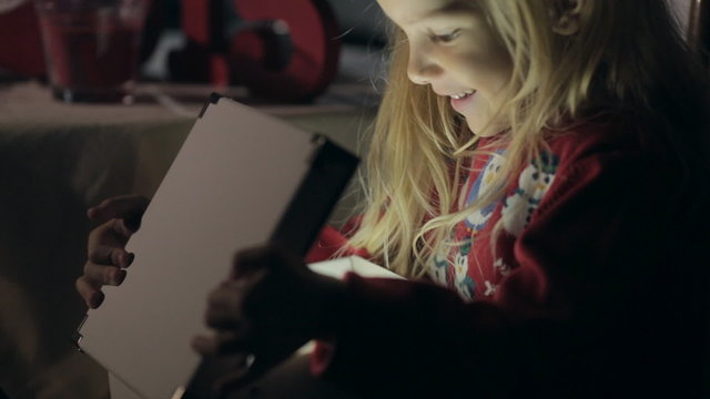 Adorable little girl with surprise and curiosity opens the box