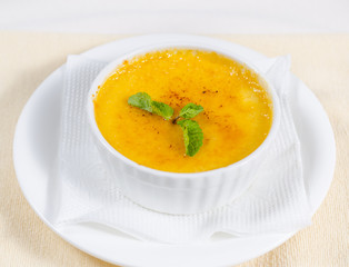Bowl of pumpkin soup with mint
