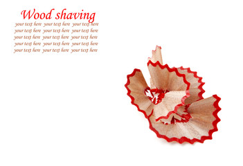 Red pencil and wood shavings isolated on white background