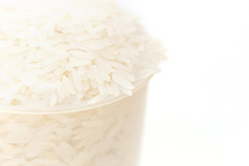 Thai jasmine rice in plastic bucket isolated on white background