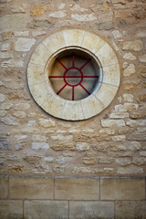 Round window on a stone wall