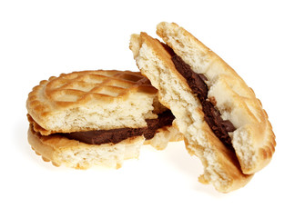 Broken sandwich biscuits with chocolate cream on a white backgro