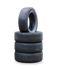 The stack of four winter new tires over white