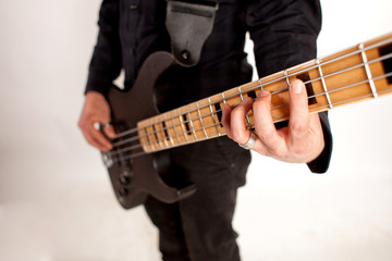Obraz na płótnie Canvas Focused bass player in black