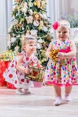 Two baby girls with christmas present