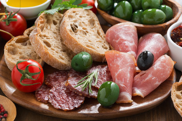 assorted Italian antipasti - deli meats, olives and bread