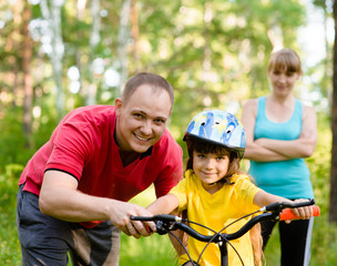 Family on cycle ride In forest