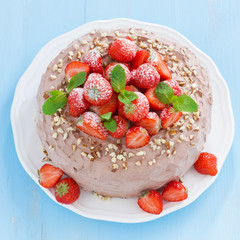 chocolate cake with fresh strawberries and mint, top view