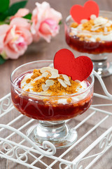 Dessert with jam and whipped cream for Valentine's Day, vertical