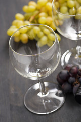empty wine glasses and grapes on wooden table