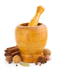 mortar with pestle and spices on white
