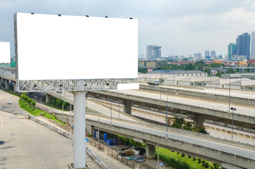 large blank billboard on road with city view background