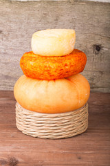several varieties of cheese on an old wooden table