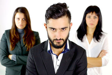 Serious business man with two women behind him