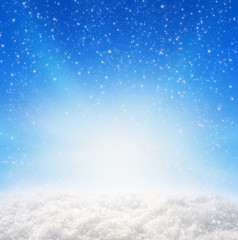 	Blue christmas background and snowfall.
