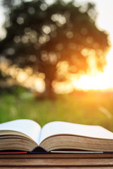 Close up book on table in sunset time