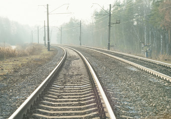 Fototapeta na wymiar Empty suburban railroad leading to the horizon on a sunny day