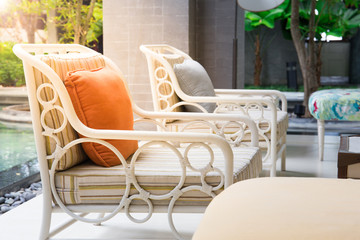 orange pillow on wooden chair