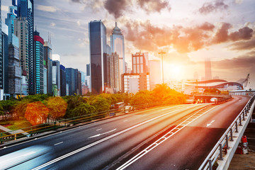 cityscape and traffic trails on the road of modern city