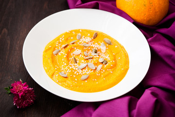 Pumpkin cream-soup with seeds in a plate