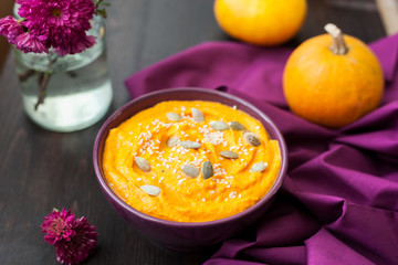 Pumpkin cream-soup with seeds in a plate