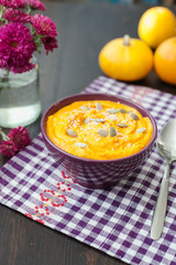 Pumpkin cream-soup with seeds in a bowl