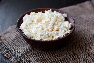 Delicious homemade cottage cheese on the wooden table