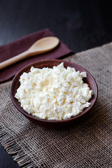 Delicious homemade cottage cheese on the wooden table