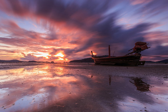 Fototapeta Silhouettes of longtail boat and sunrise in Phuket, Thailand