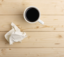 cup of coffee and crumpled paper