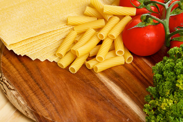 Uncooced lasagne pasta sheets on wooden table