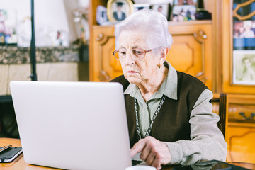 Fototapeta premium Senior woman with laptop at home