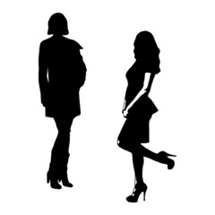 Silhouettes of two women on isolated white background.