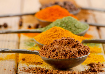 dried spices in spoons.