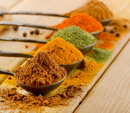 Selection of dried spices in spoons.