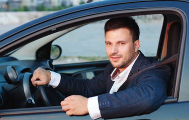 smiling man in the car, happy driver