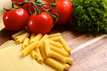 Uncooced lasagne pasta sheets on wooden table
