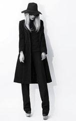 Fashion Black and white photo. Glamorous blonde in classic coat