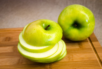 The apple cut with circles on a wooden board