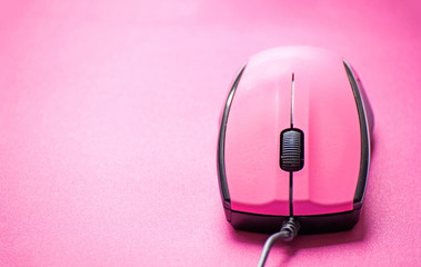 Pink computer mouse on pink background