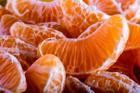 Tangerine or mandarin orange segments peeled close up background