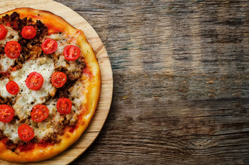 pizza with meat, mozzarella and tomatoes